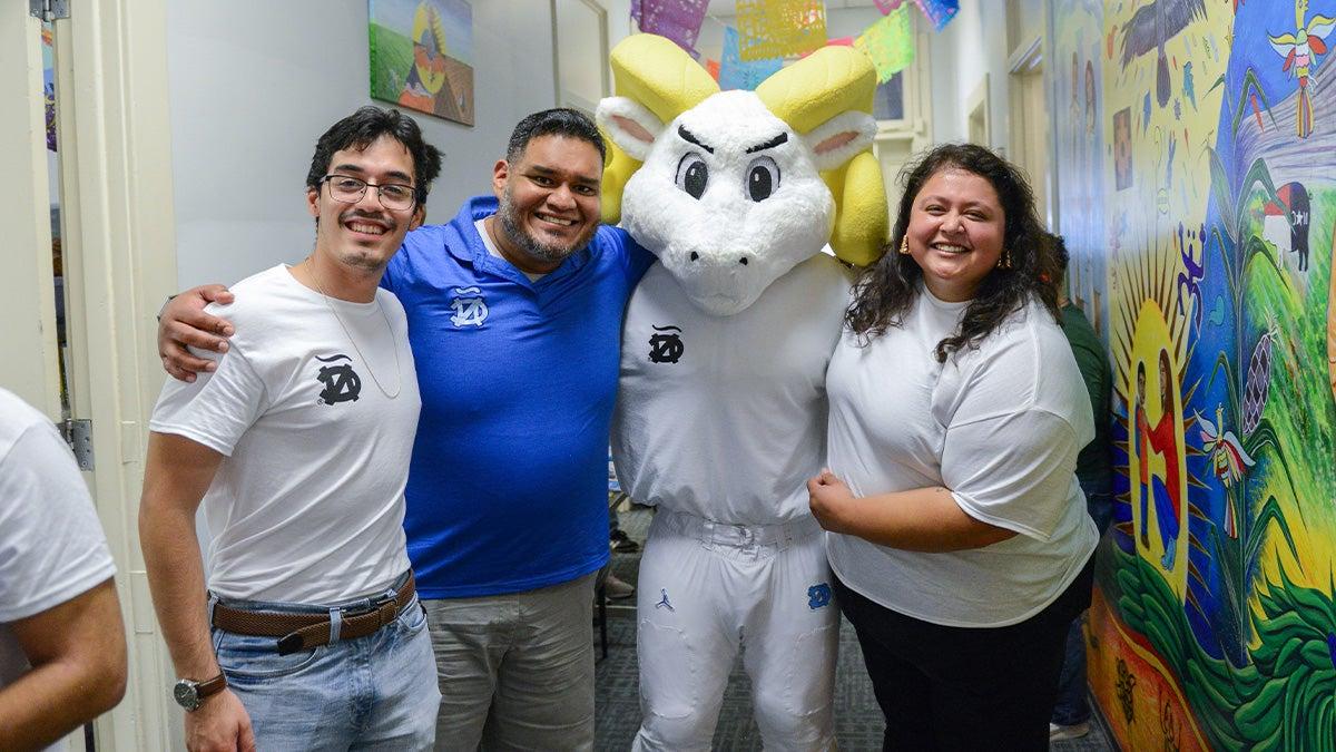 Members of the Latinx community pose for a photo with Rameses in the middle.